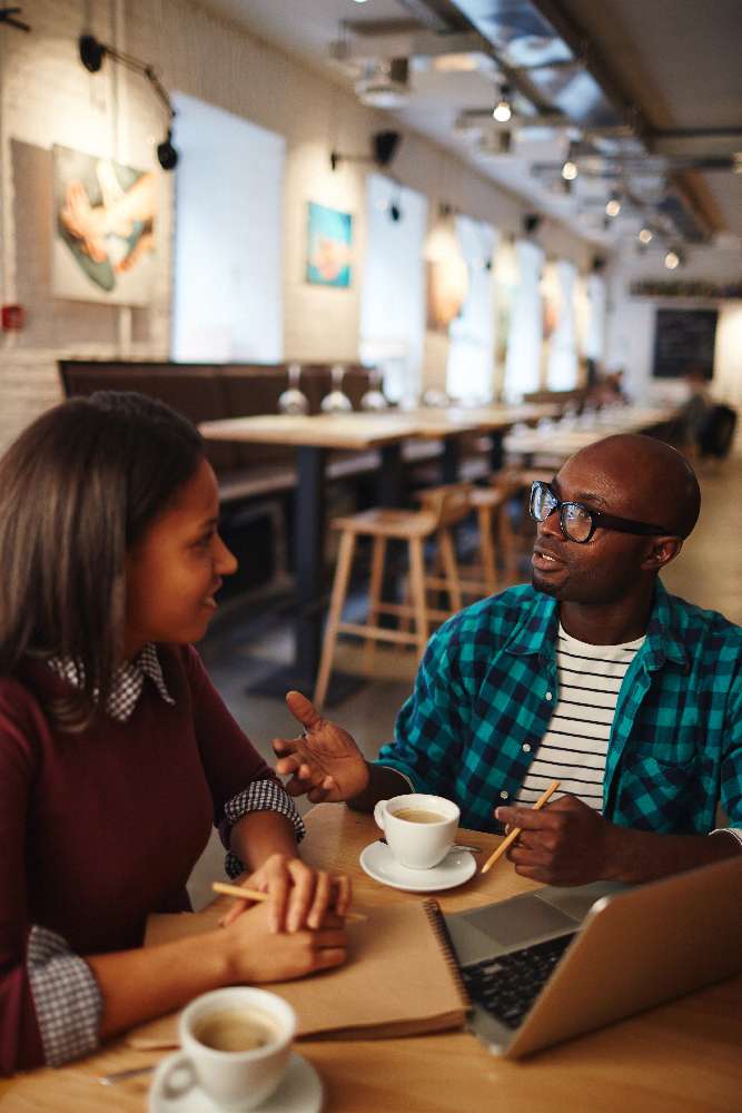 two people enjoying their time in their third place, a coffee shop