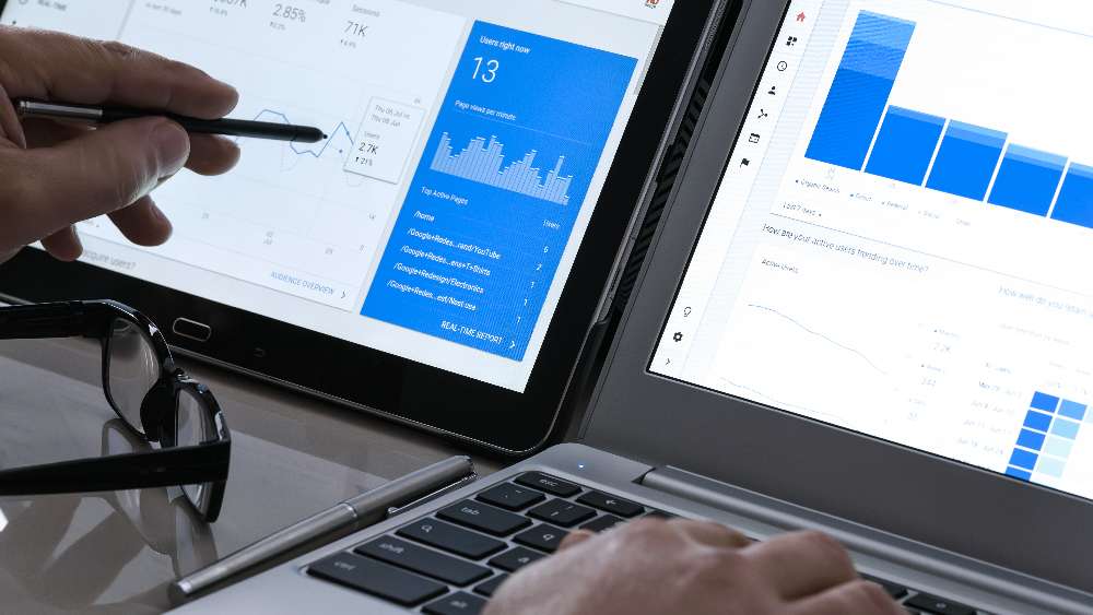 Krynica-Zdroj, Poland - July 11, 2017: Businessman using Google Analytics in the office on the touch screen of his tablet. Google Analytics is the most famous application for advanced web traffic analysis in the world