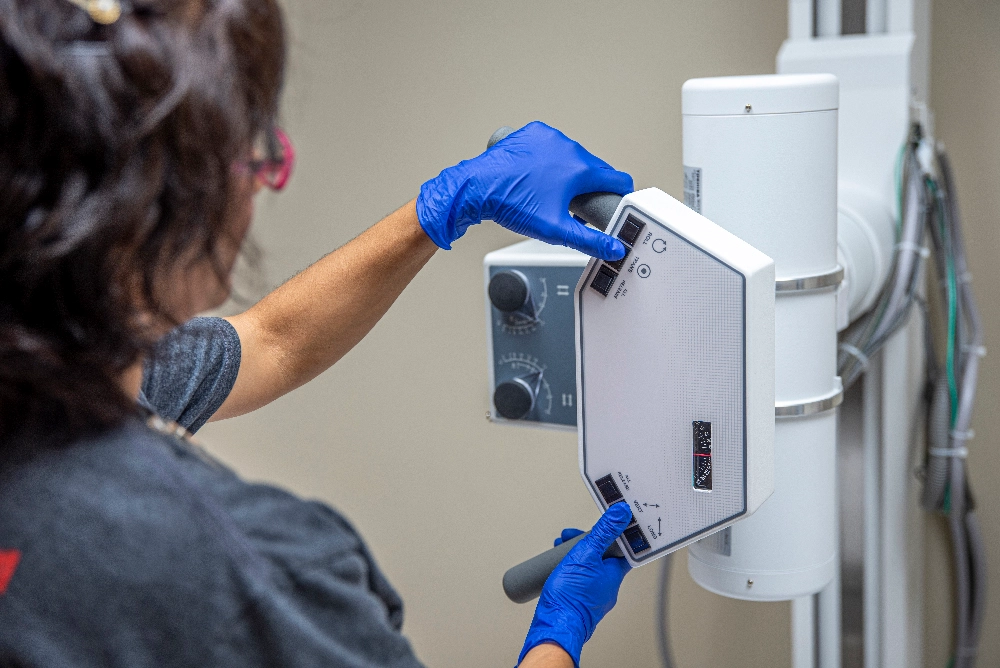 medical employee working on an xray machine, medical marketing photography