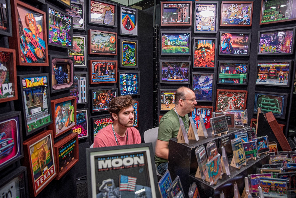 event marketing picture of a booth selling video game frames at a comic convention