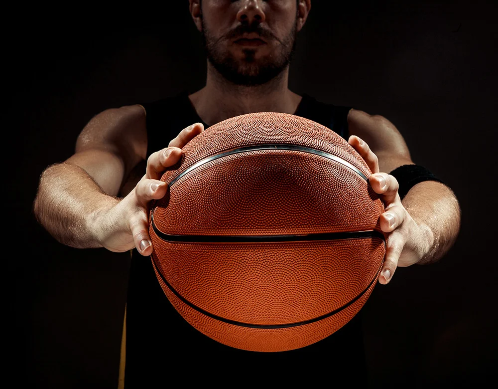 silhouette-view-basketball-player-holding-basket-ball-black-background