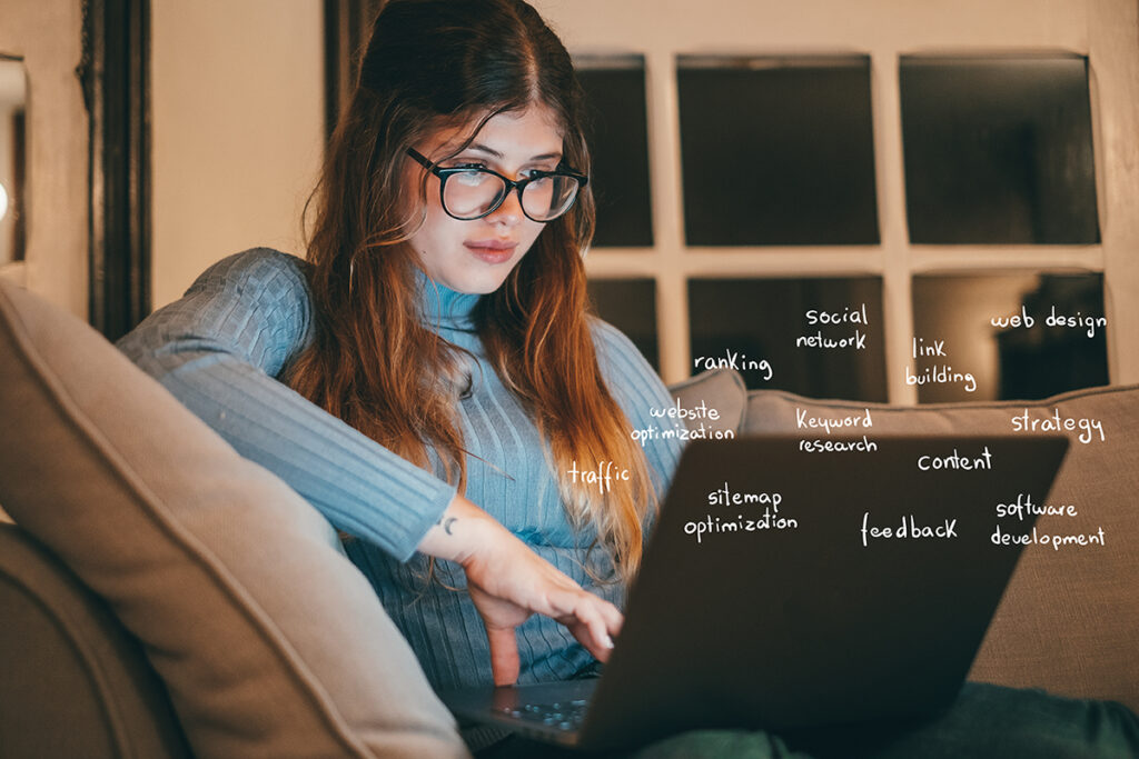 young girl on laptop looking at traditional seo techniques with words around her laptop