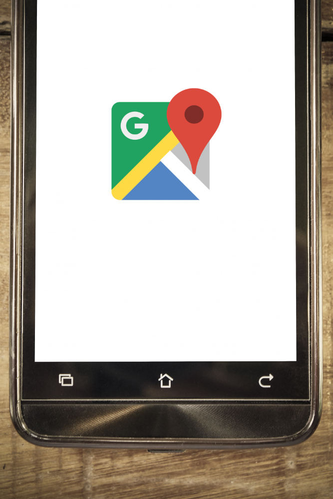 a cloesup of a mobile phone with the google maps logo on the screen as part of local seo strategy