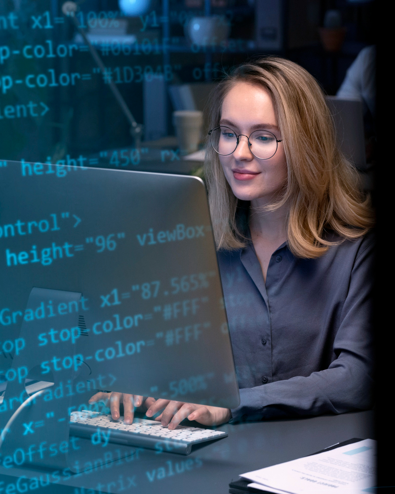 female with glasses working on technical SEO looking at a computer screen