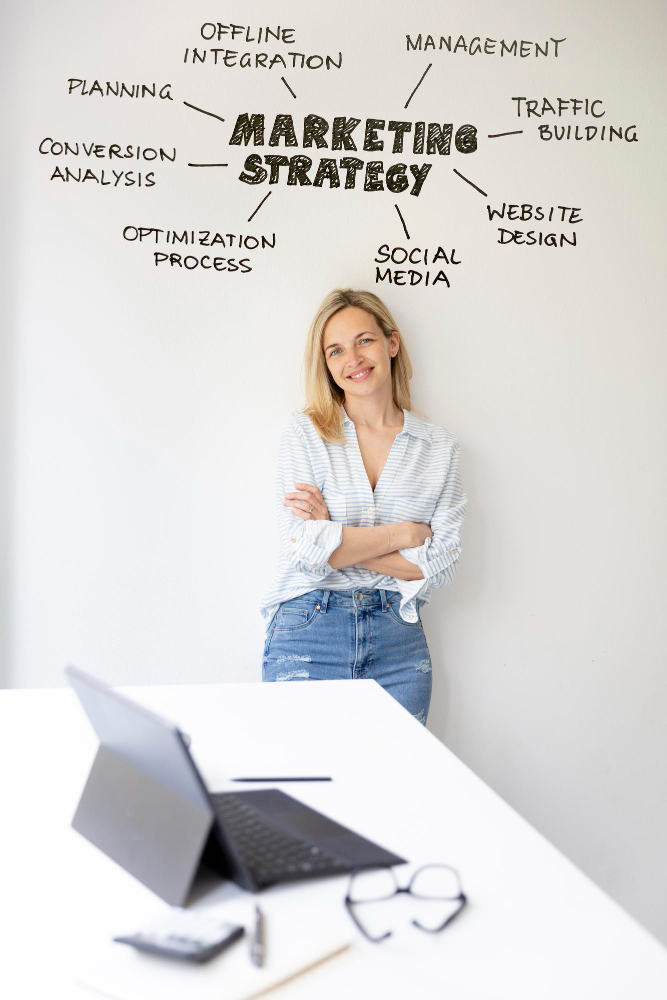 woman standing in front of digital marketing graphics behind her on th wall