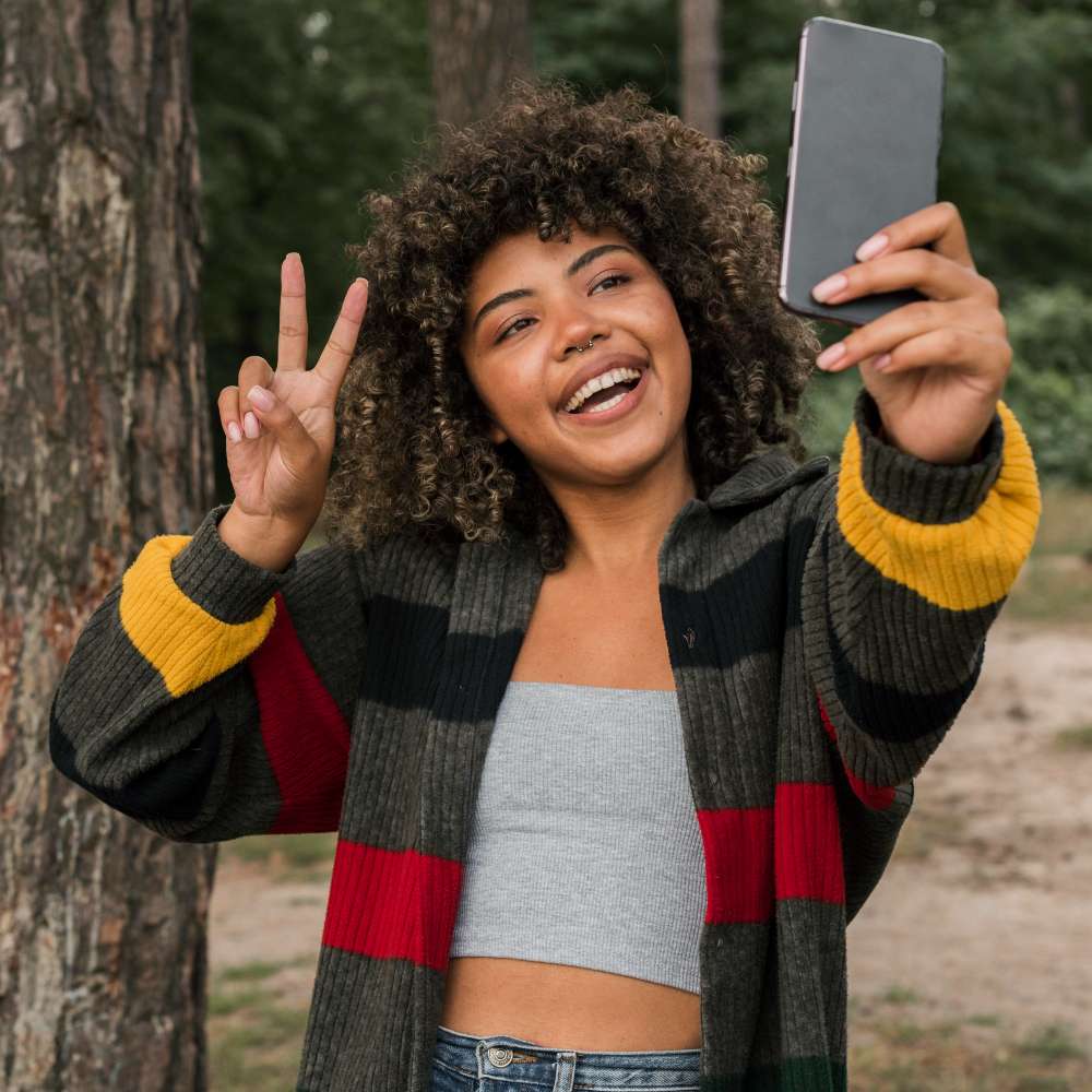 a woman taking a selfie for social media marketing purposes