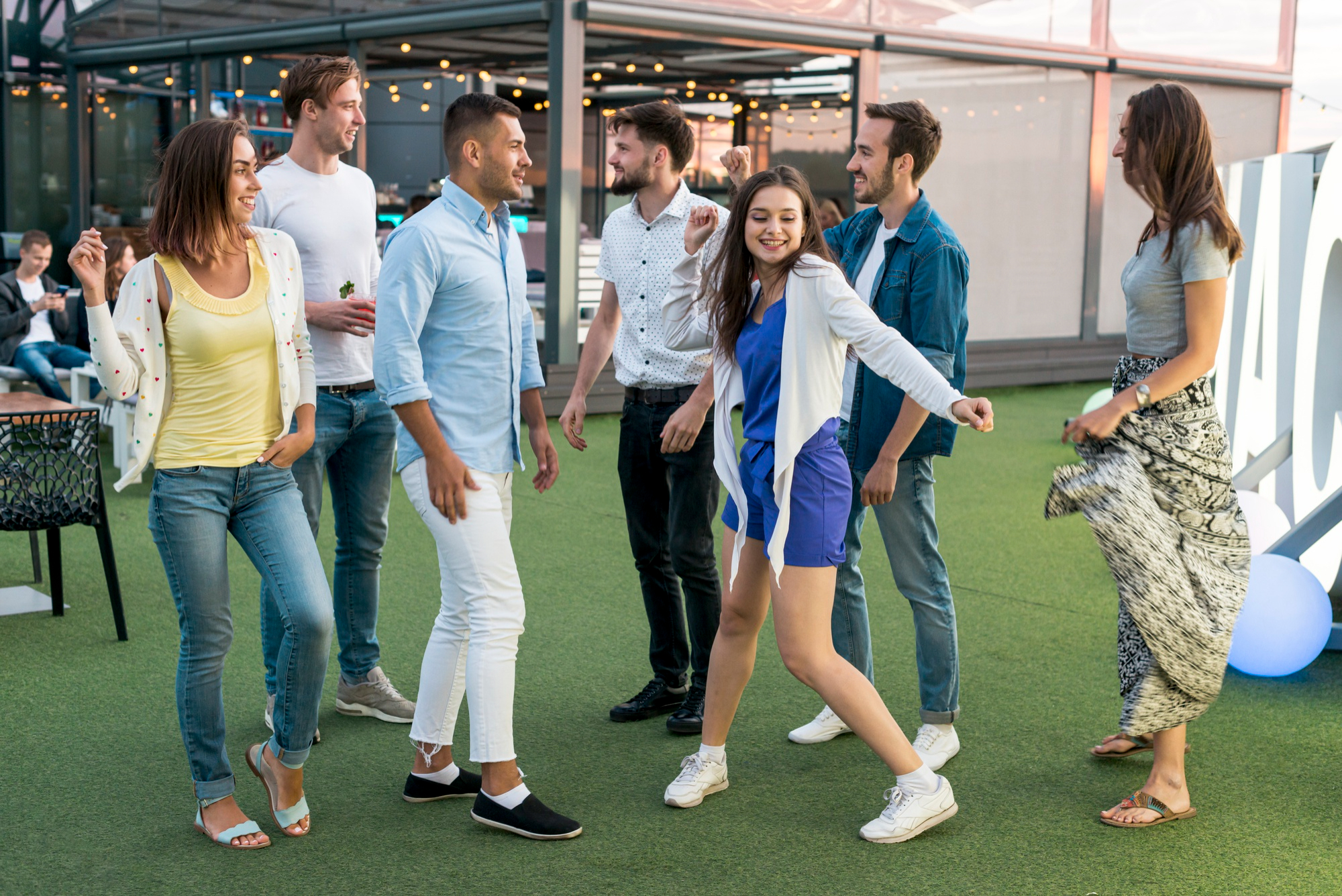 a group of young adults edancing and enjoying an event marketing conference